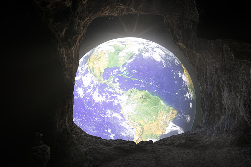 Earth day view of the planet earth from cave hole in fancy image in save earth concept. Elements of this image furnished by NASA
