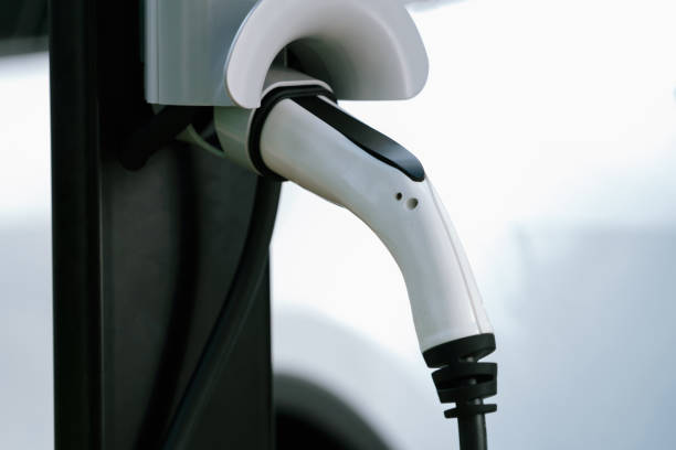 istock Closeup EV charging station with charger plug connected power sauce. Synchronos 2149094876