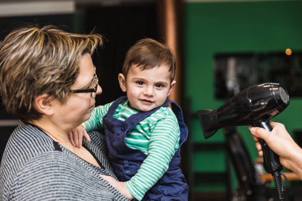 istock Toddler's first haircut at a barbershop 2149096317