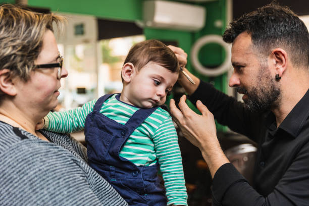 istock Toddler's first haircut at barber shop 2149096360