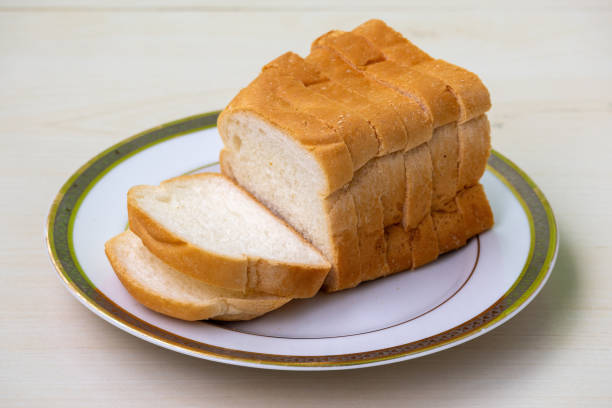 istock Slices of bread on a white plate on wooden surface 2149096758