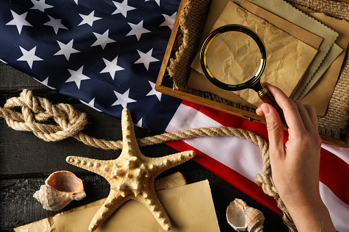 Columbus Day. Magnifying glass with old letters and American flag