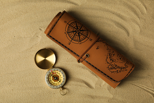 Sea travel concept. Vintage compass on the sand