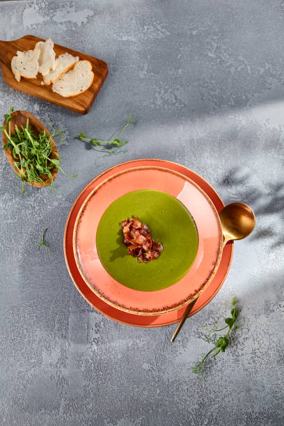 istock Broccoli cream soup with crispy bacon topping on rustic ceramic, top view for a healthy and hearty meal 2149097242