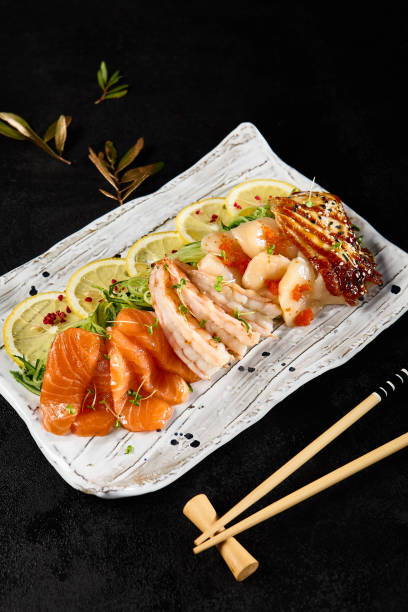 istock Diverse Sashimi Platter Featuring Salmon, Shrimp, Scallop, and Eel on Elegant Tableware 2149097390