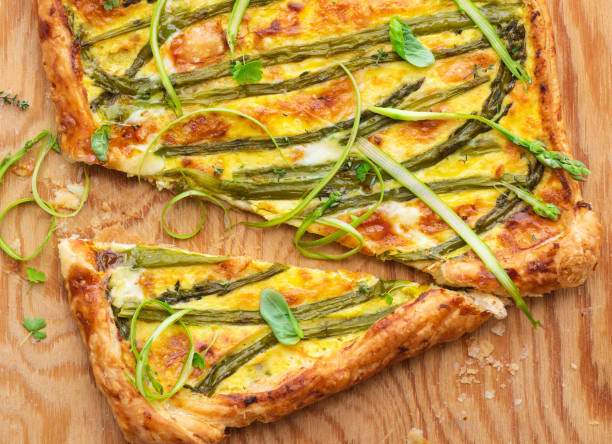 istock Asparagus pie or tart with eggs, cheese and aromatic herbs, spring Easter recipes. French healthy cuisine, Provencal herbs, azure background. Spring asparagus 2149097457