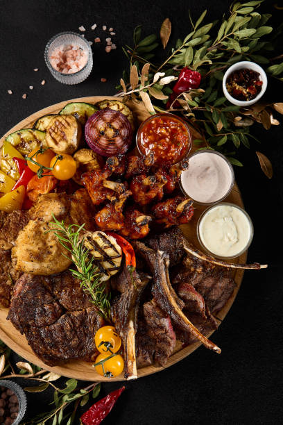 istock Assorted Grilled Meat and Vegetable Platter with BBQ Ribs, Lamb Chops, and Beef 2149097595
