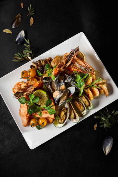 istock Exquisite Seafood Platter Presentation Featuring Mussels, Salmon, Shrimp, and Octopus on a Sleek Plate 2149097620