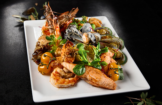Gourmet Seafood Platter Presentation Featuring Mussels, Salmon, Shrimp, and Octopus.