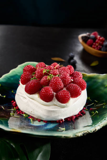 istock Elegant Pavlova Dessert with Fresh Raspberries Served on a Chic Plate 2149097624