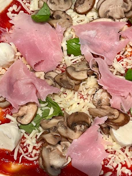 Hot tasty traditional pizza with ham and mushrooms