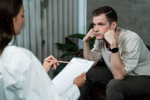 istock Stressed and depressed patient seeking help from psychiatrist. Unveiling 2149102414