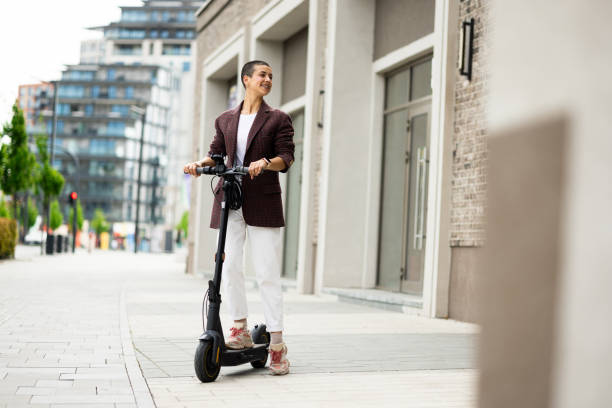 istock Woman confidently riding her push scooter to work 2149103037