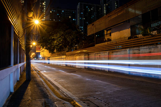 vehicle trail with long exposure at night. transport drives along an asphalt road with street lights