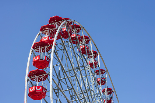 Low angle view of a big wheel at an outdoor travelling carnival in the North East of England.

Videos are available similar to this scenario.