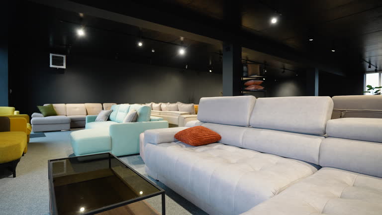 Couches and sofas displayed for sale in showroom at furniture store