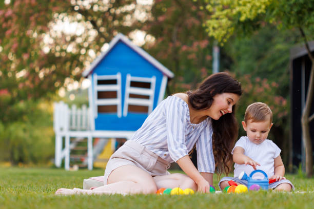 istock Mother and toddler boy playing in the park while having picnic 2149107295