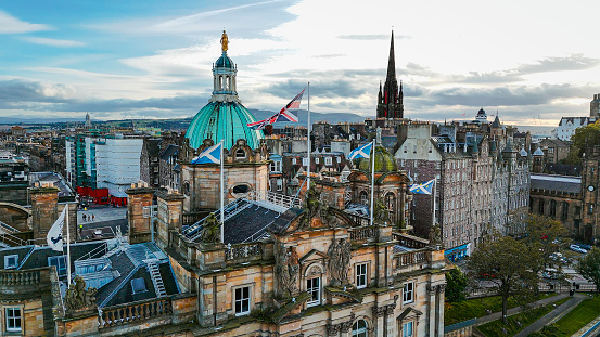 Aerial view of Edinburgh old town, Aerial view of Old cathedral in Edinburgh, Edinburgh city centre, Gothic Revival architecture in Scotland, Flag of Scotland and UK  in Edinburgh, Aerial view of Bank of Scotland