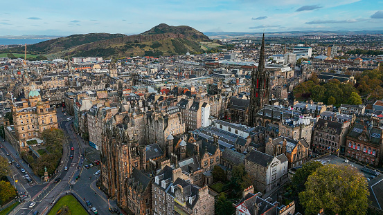 Aerial view of Edinburgh old town at sunset with Tolbooth Kirk Church, sunset aerial view of the Old Town and Royal Mile in Edinburgh, The Hub high tower church in Edinburgh city centre, Gothic Revival architecture in Scotland