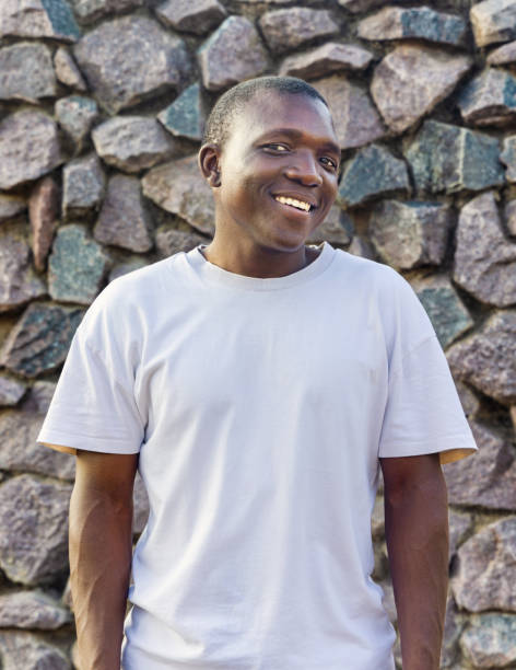 istock smiling young african man with casual clothing, stone background 2149111917