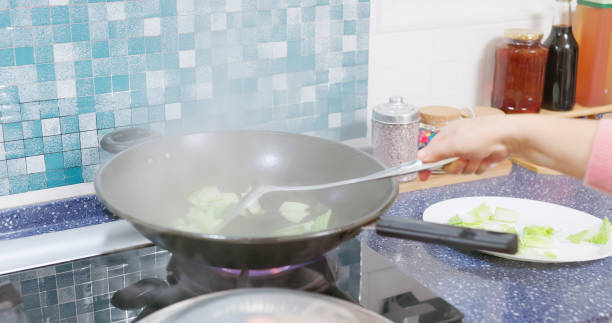 istock elderly woman kitchen oil smoke 2149114986