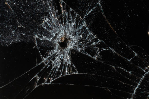 istock Bullet hole in a glass on the black background.closeup. 2149116328