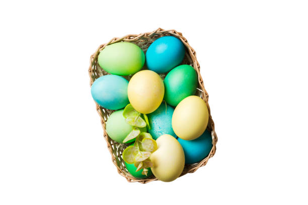 istock Basket of colorful Easter eggs isolated on white background. Easter basket filled with colored eggs top view holiday concept 2149116617