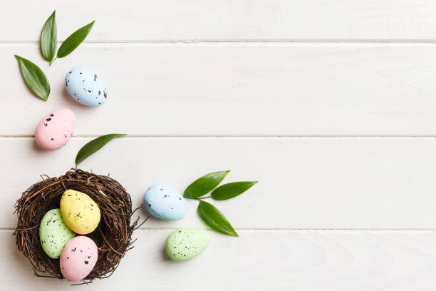 istock Colorful easter eggs in nest on table background with copy space top view 2149116641