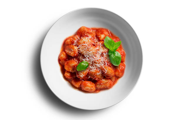Top view White bowl with tomato potato dumpling with cheeese and basil on white background
