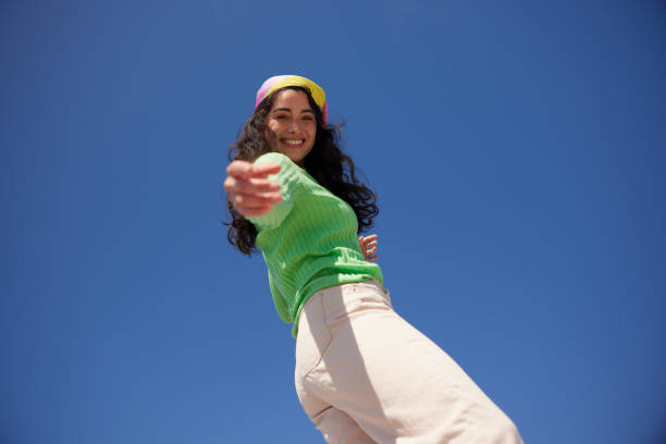 istock Empowering Reach: A Stylish Young Woman's Confident Gesture 2149119233