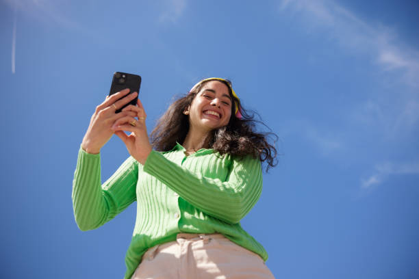 istock Smartphone Chic: A Playful Young Woman Embracing the Future 2149119319