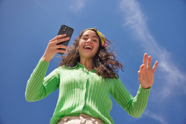 istock Digital Optimism: Young Woman's Playful Smartphone Stance 2149119325