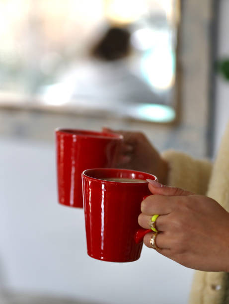istock A woman holds two cup of coffee. 2149119326