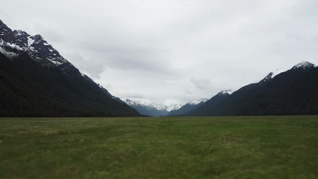 Racing over the golden tussock grasslands towards the Eglinton Valley, Fiordland in New Zealand.