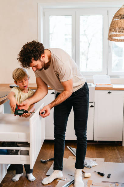 istock Father and son assembling kitchen furniture 2149121878