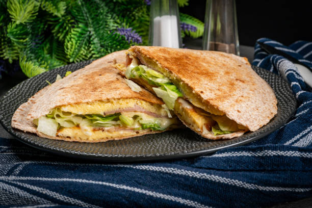 istock Tortilla multigrain with omelette, lettuce and ham. 2149123318