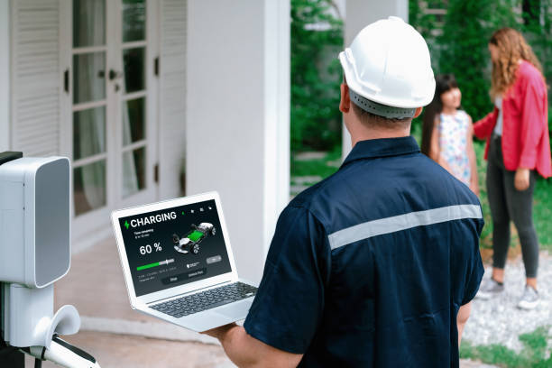 istock Qualified technician working with laptop for home EV station. Synchronos 2149123508