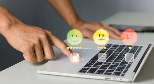 istock Customer service evaluation concept. businessman pressing face on a virtual touch screen at a laptop, feeling satisfied, high score, good review, impressed, Customer Satisfaction Survey Concept. 2149124387
