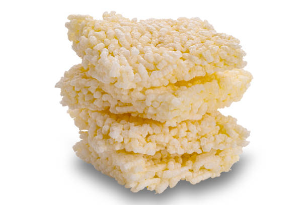 Closeup view stack of crispy homemade rice crackers isolated on white background with clipping path.