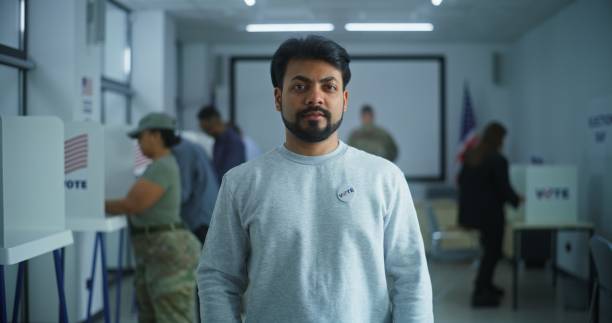 istock Indian man stands in a modern polling station and poses 2149125572