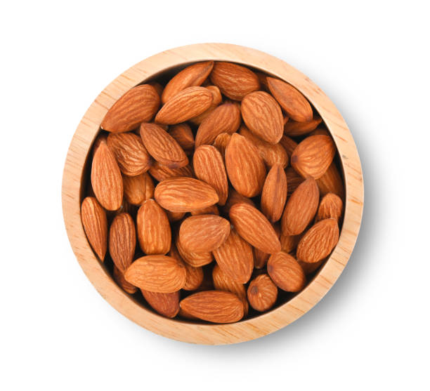istock Almonds in wood bowl isolated on white background. top view 2149126299