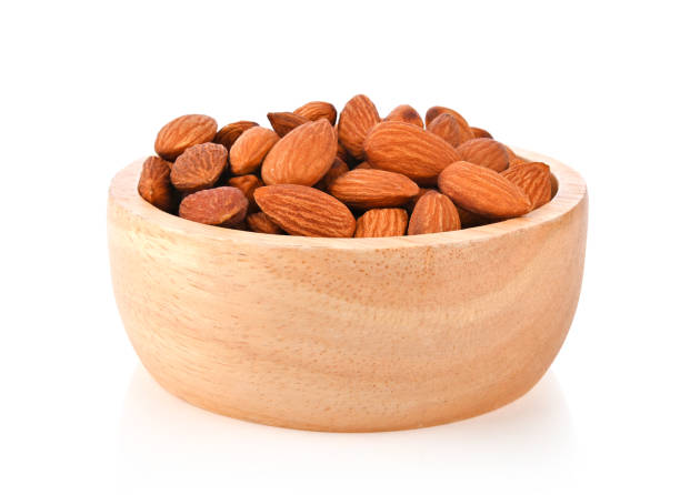 istock Almonds in wood bowl on white background. 2149126414