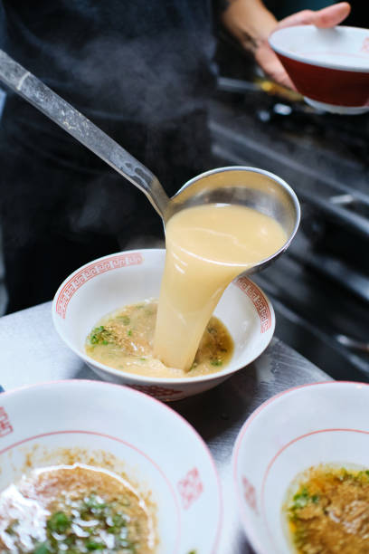 istock Crop person pouring bouillon in bowl 2149126985
