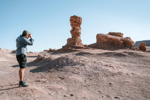 istock Photographer Capturing Unique Rock Sculpture in Atacama Desert 2149127331