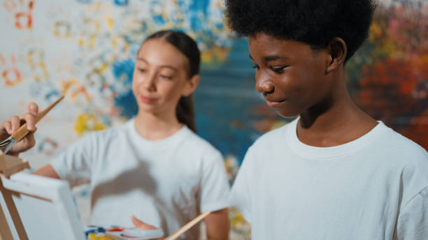 istock Diverse happy children paint canvas together with stained wall. Edification. 2149127532