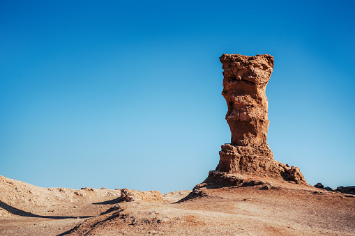 Stunning view of an iconic rock sculpture set against the vast, clear skies of the Atacama Desert in Vallecito, Chile.