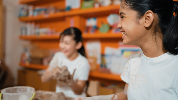 Two little boys are learning to make pottery