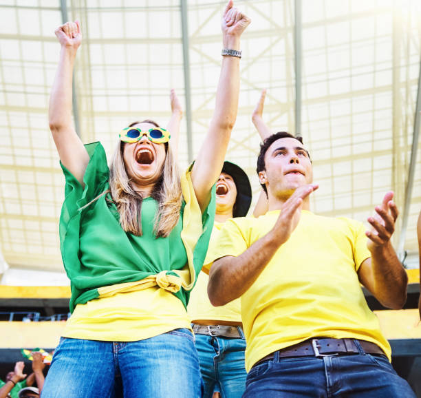 istock Excited young people cheering at a soccer match 2149128282