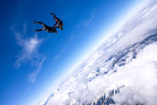 istock Freefall jumpers hold hands mid-air 2149130215