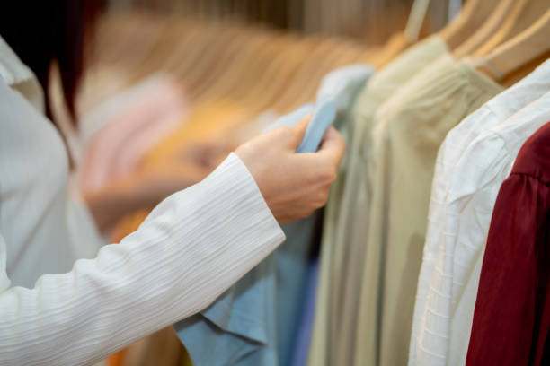 istock Close-Up of Consumer Picking Clothes on Rack 2149130418